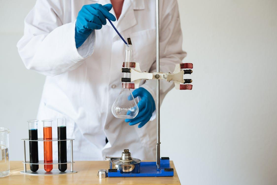 Phosphoric Acid vs. Sulfuric Acid: Which to Choose? 15 A faceless Asian scientist conducting precise chemical analysis in a modern laboratory.