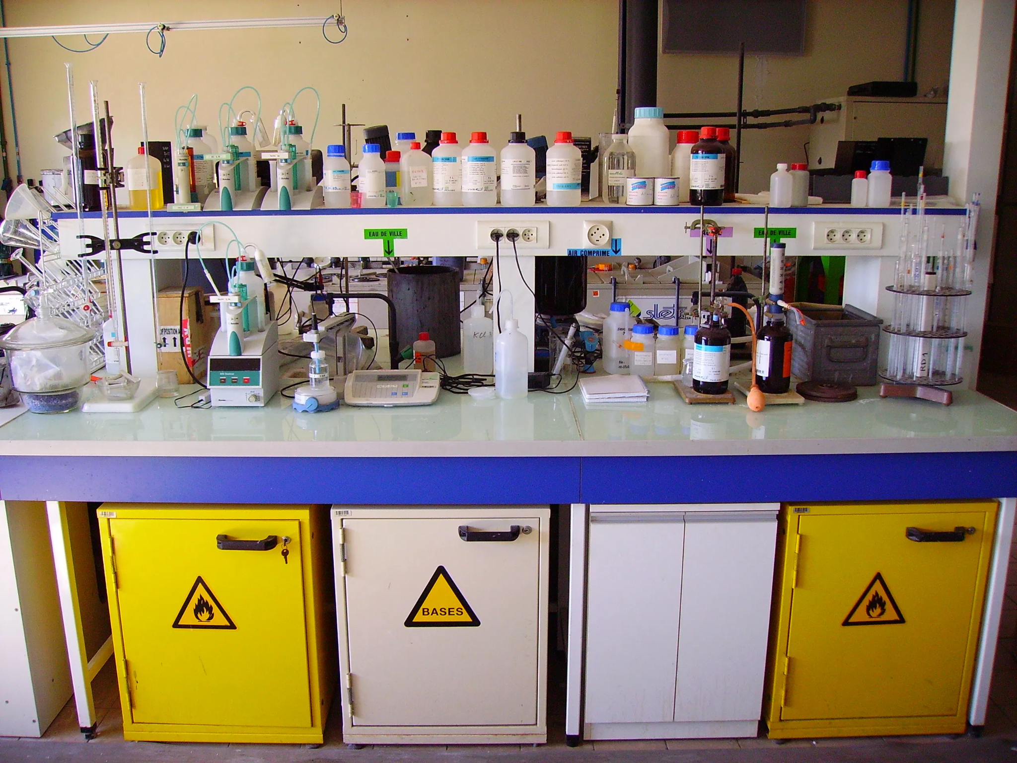Analytical chemistry laboratory bench with glassware and equipment used for sample testing and quality control.