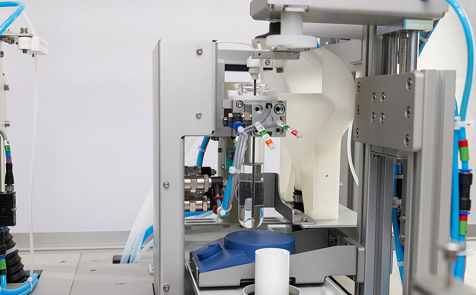 Automated titration and liquid dosing equipment analyzing liquid chemical samples in a glass beaker