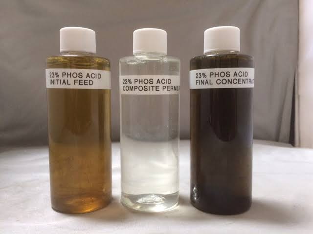 Three sample bottles containing 23% phosphoric acid showing initial feed, clear composite permeate, and dark final concentrate stages during chemical purification