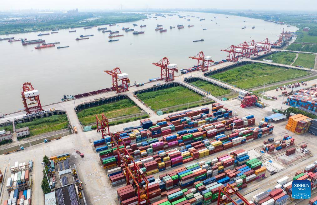 Busy container port with colorful shipping containers and cranes along the Yangtze River