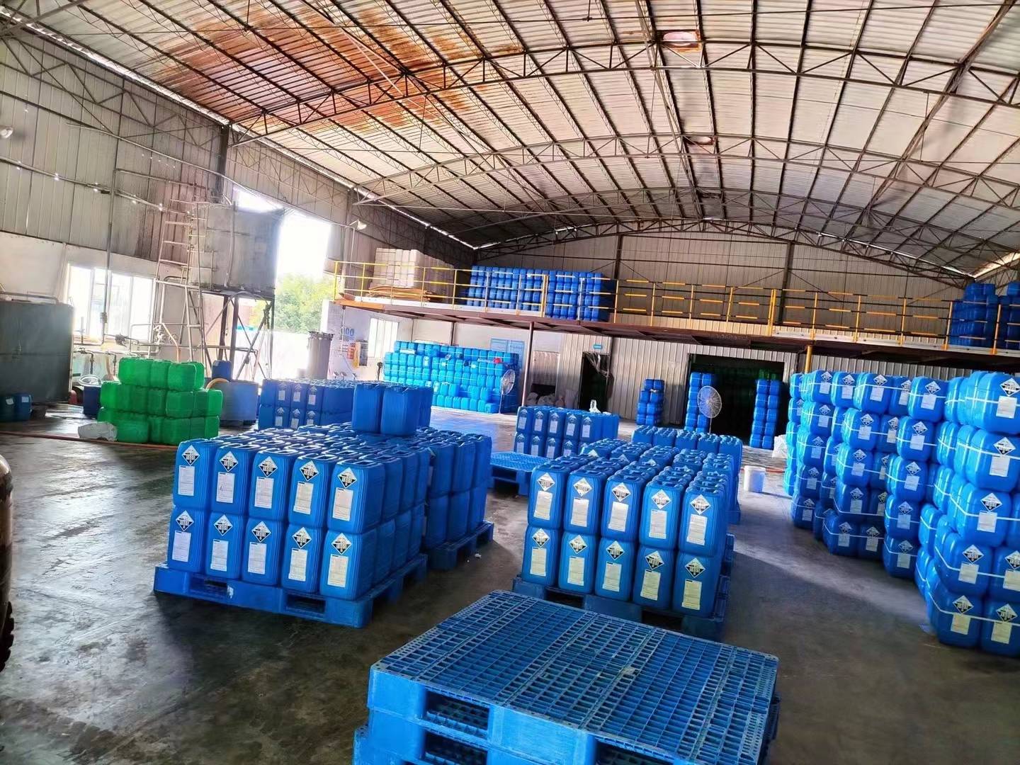 Large blue IBC tanks used for the bulk storage and transportation of phosphoric acid.