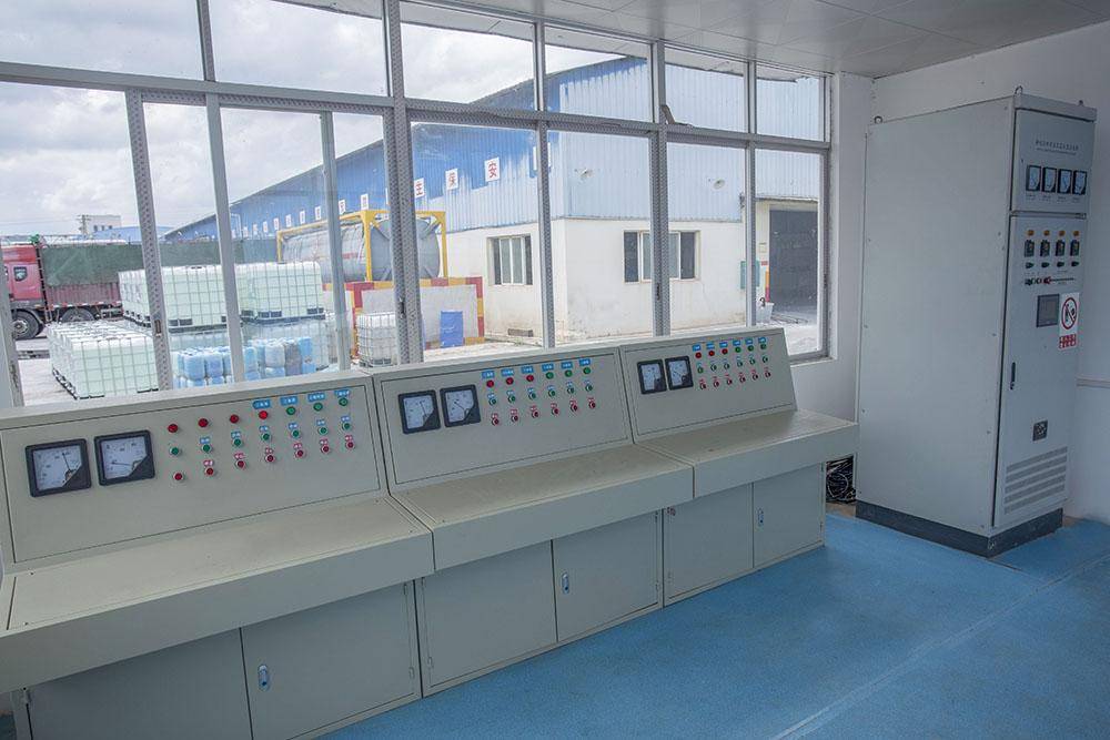 State-of-the-art phosphoric acid production and testing equipment inside a manufacturing facility.
