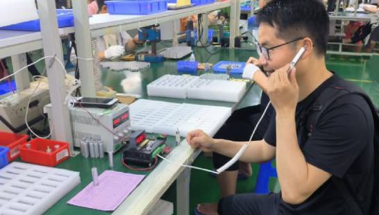 Quality control technician inspecting raw materials and testing electronic equipment used in chemical analysis for phosphoric acid manufacturing compliance